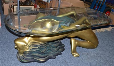 Lot 704 - An Art Deco style glass top coffee table in the form of a nubile woman