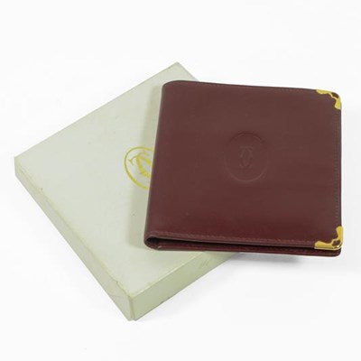 Lot 2231 - Cartier Burgundy Leather Wallet, stamped in...