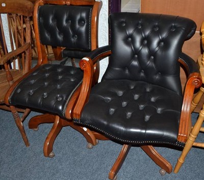 Lot 778 - Two modern leather swivel chairs