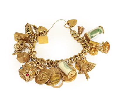 Lot 102 - A charm bracelet, hung with various charms...