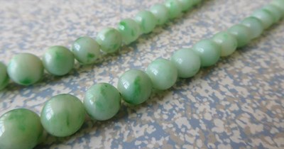 Lot 107 - A graduated jade bead necklace, length 73cm,...