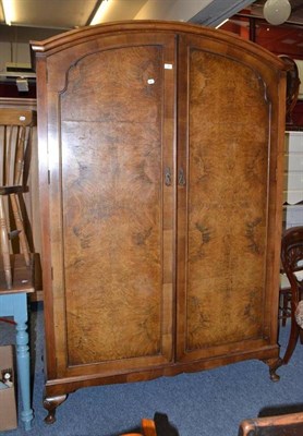 Lot 787 - A walnut double door wardrobe