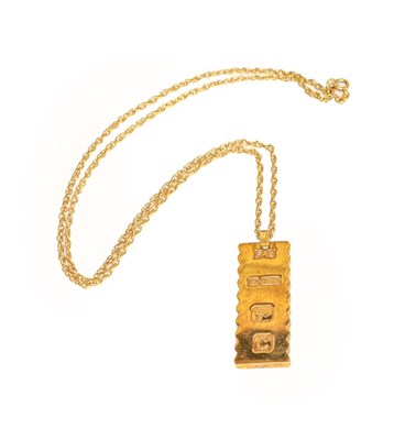 Lot 129 - A 9 carat gold ingot on chain, chain stamped...