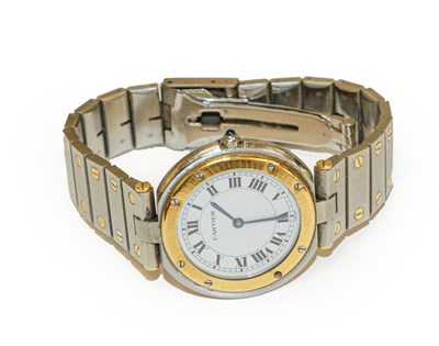 Lot 143 - A steel and gold wristwatch, signed Cartier,...