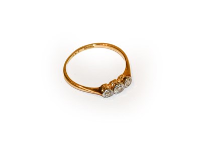 Lot 150 - A diamond three stone ring, stamped '18CT',...