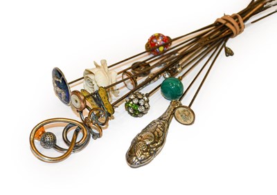 Lot 153 - A collection of hat pins including a silver...