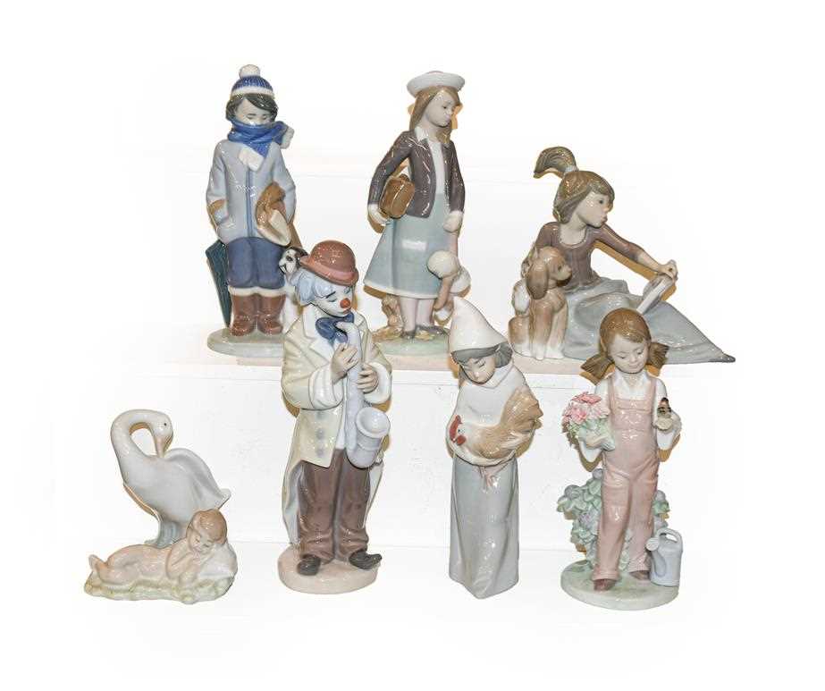 Lot 20 - Eight Lladro figures including a clown playing...