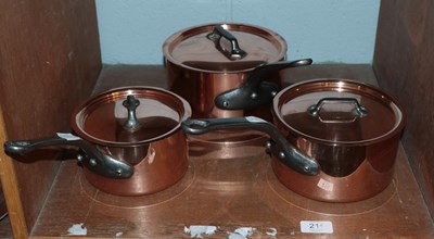 Lot 215 - A set of three graduated covered saucepans,...