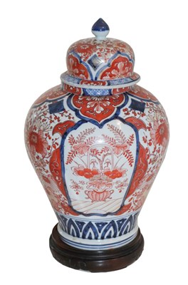 Lot 221 - A Japanese Imari vase, cover and hardwood...