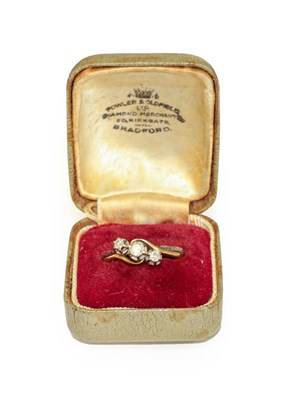 Lot 100 - A diamond three stone twist ring, stamped...
