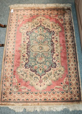 Lot 1154 - A machine made rug of Oriental design, the...