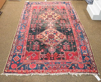 Lot 1170 - Caucasian design rug, the field with three...