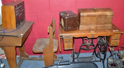 Lot 842 - A child's school desk, a treadle sewing machine, walnut 1930s radio and a Bakelite radio