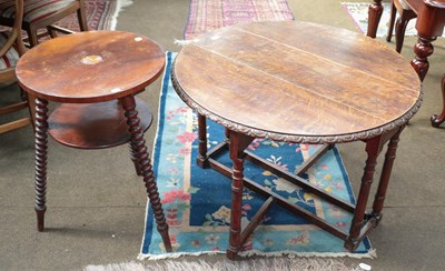 Lot 1210 - A 1920's oak gateleg table with lunette carved...