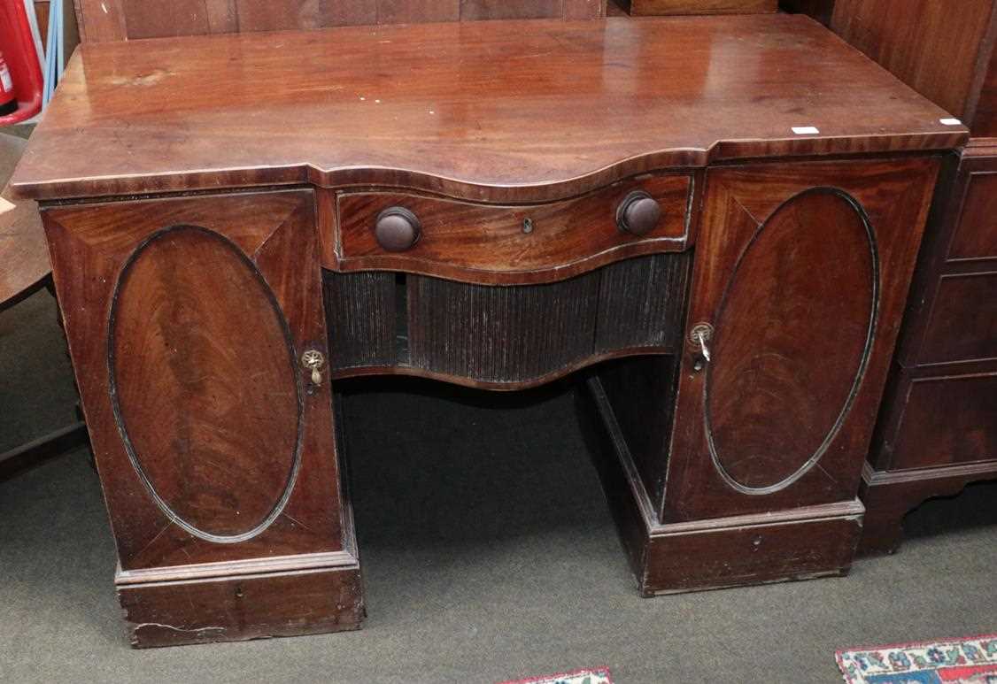 Lot 1215 - A Georgian figured mahogany serpentine fronted...