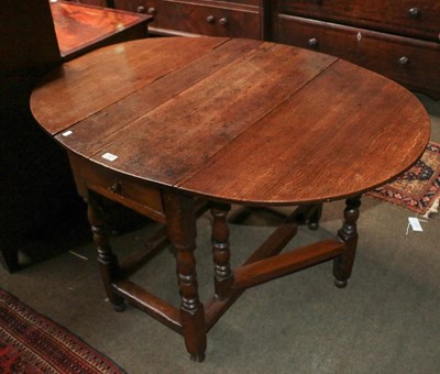 Lot 1221 - An 18th century oak gateleg table with single...