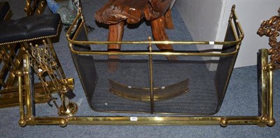 Lot 845 - A spark guard, brass fender, a small brass fender and a brass fire companion set