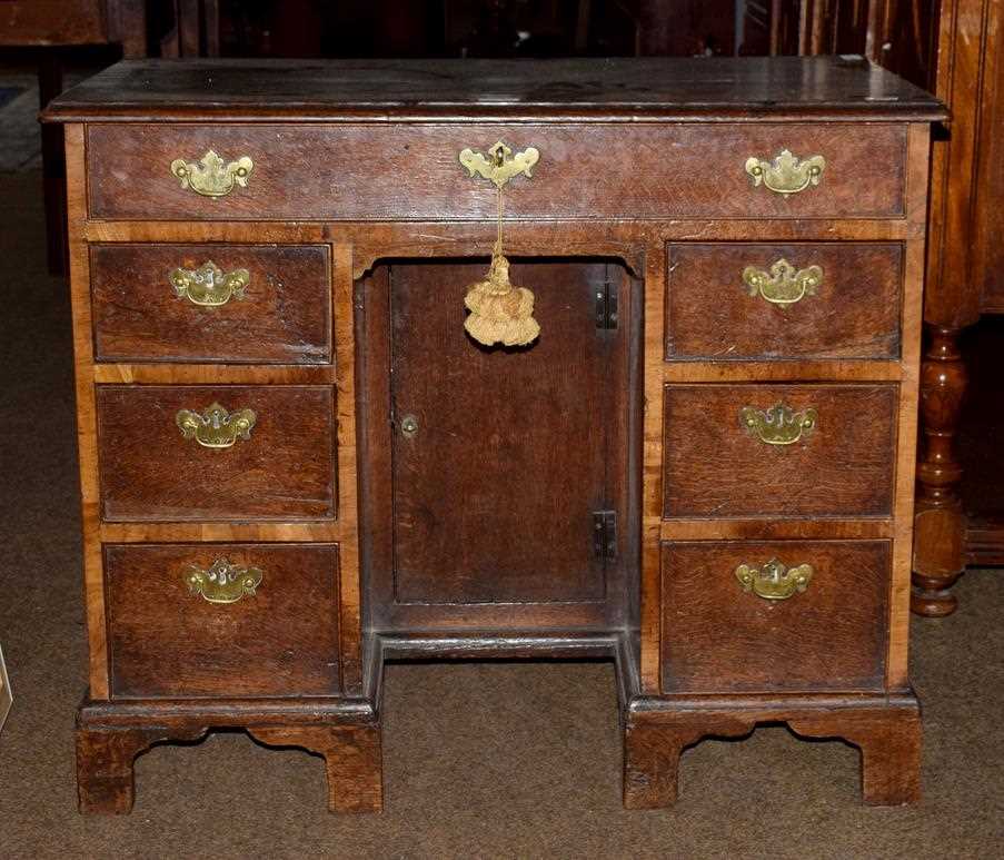 Lot 1242 - A George II oak kneehole dressing table, the...