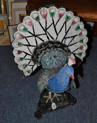 Lot 848 - A 20th century painted metal garden peacock, stamped 'LM Ltd'