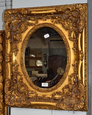 Lot 1271 - A reproduction ornate gilt framed mirror with...