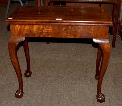 Lot 1277 - A 19th century mahogany foldover tea table on...