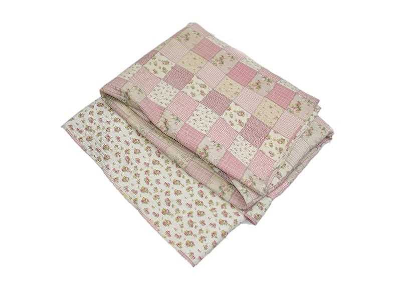 Lot 1028 - A 20th century pink floral patchwork quilt,...