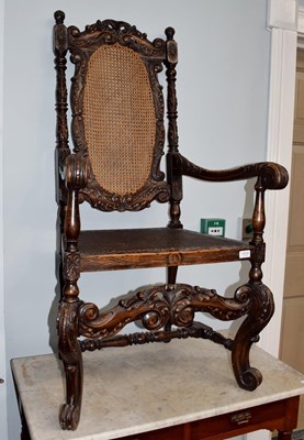 Lot 1313 - A carved oak open armchair with carved back...