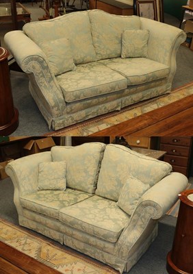 Lot 1333 - A pair of blue floral upholstered two seater...