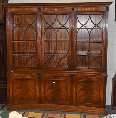 Lot 1342 - A reproduction concave mahogany bookcase,...