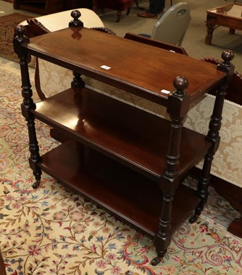 Lot 1363 - A mahogany three-tier whatnot, each moulded...
