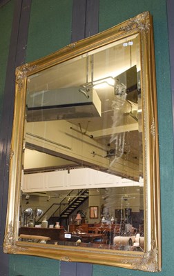 Lot 1377 - A large gilt framed mirror with bevelled plate,...