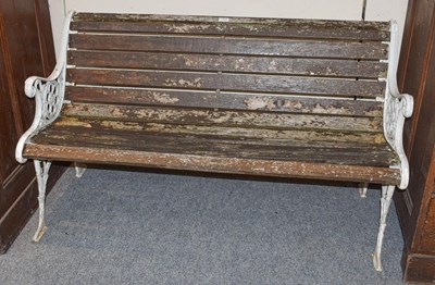 Lot 1390 - A Victorian garden bench with cast iron ends...
