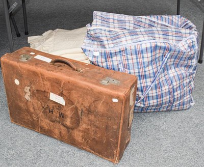 Lot 1078 - A leather suitcase containing assorted lace...