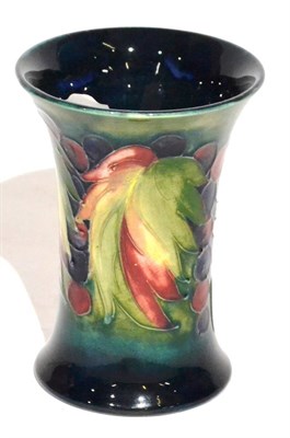 Lot 8 - A Walter Moorcroft Leaf and Grape Pattern Trumpet Vase, impressed POTTER TO H.M THE QUEEN and...