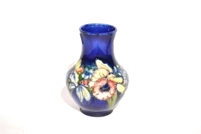 Lot 9 - A Walter Moorcroft Orchid and Spring Flowers Pattern Vase, impressed POTTER TO H.M THE QUEEN...