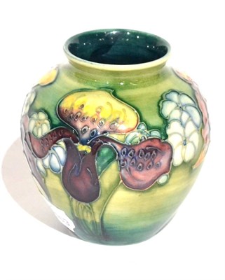 Lot 11 - A Walter Moorcroft Orchid and Spring Flowers Pattern Vase, on a green wash ground, impressed...