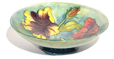 Lot 13 - A Walter Moorcroft Hibiscus Pattern Footed Bowl, on a blue wash ground, impressed factory...