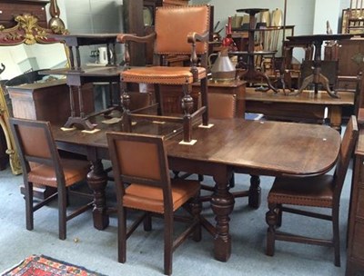 Lot 1272 - A George V oak drawer leaf dining table on...