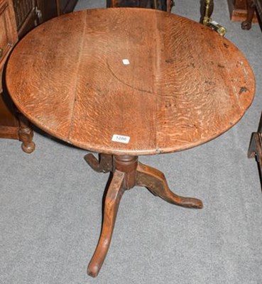 Lot 1286 - A George III oak circular tripod table,...