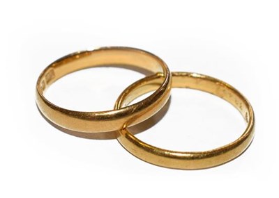 Lot 182 - Two 22 carat gold band rings, finger sizes...