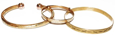 Lot 239 - A 9 carat gold baby's bangle, a bangle stamped...