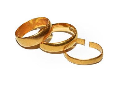 Lot 271 - Three 22 carat gold band rings, finger sizes...