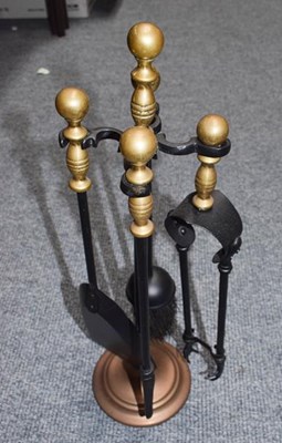 Lot 325 - A small brass and iron fireside companion set