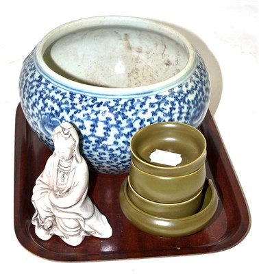 Lot 91 - A blue and white bowl, four celadon bowls and a blanc de chine figure - all modern