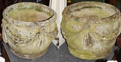 Lot 424 - A pair of garden planters decorated in relief...