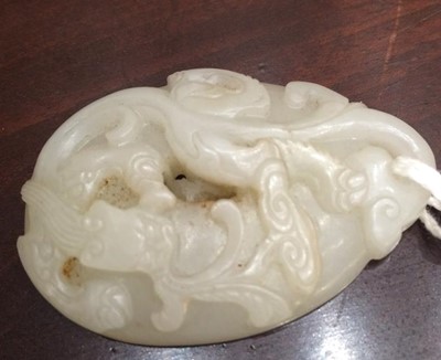 Lot 216 - A Chinese Jade Pendant, of oval form, carved...