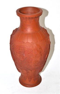 Lot 130 - A Chinese terracotta vase decorated with duelling dragons