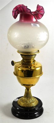 Lot 166 - Brass oil lamp and modern shade