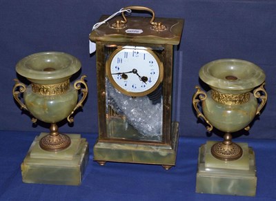 Lot 203 - An onyx four glass clock garniture