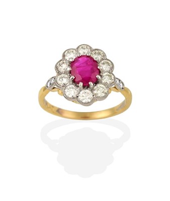 Lot 2218 - A Ruby and Diamond Cluster Ring, the oval cut...